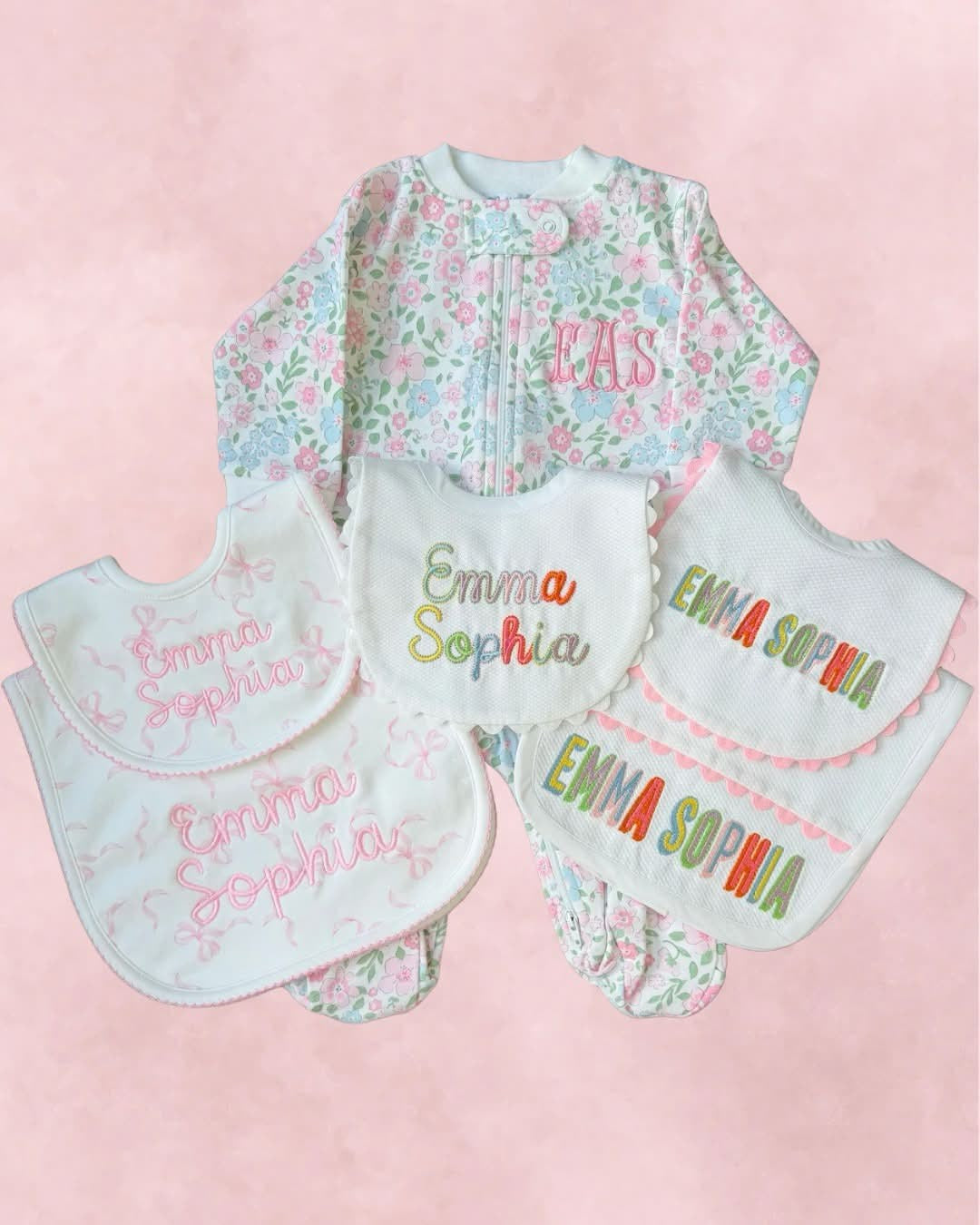 A multi-piece embroidered baby set with matching bibs